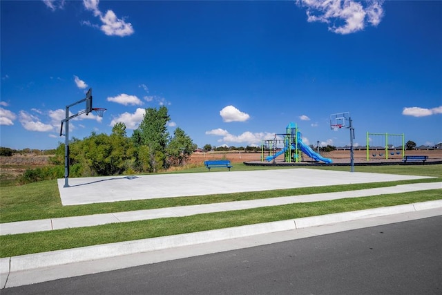 view of jungle gym with basketball court and a yard