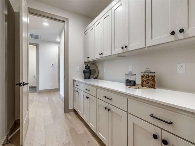 interior space featuring white cabinetry and light hardwood / wood-style floors