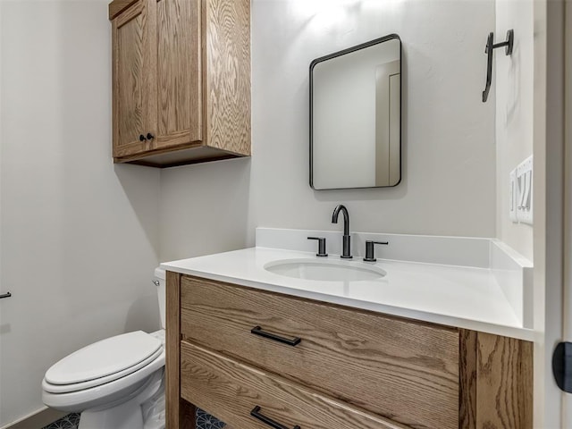 bathroom with toilet and vanity