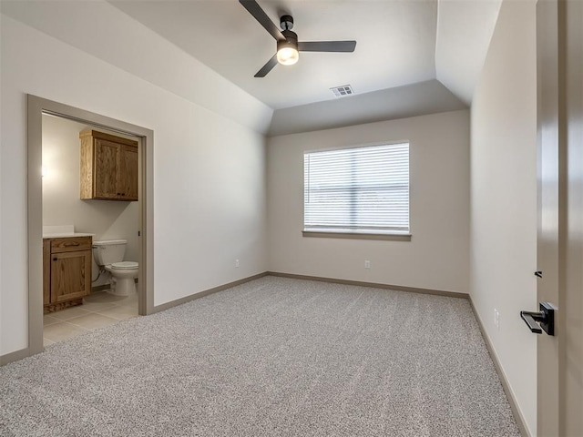 carpeted empty room with ceiling fan and vaulted ceiling