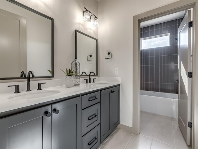 bathroom with tiled shower / bath combo, tile patterned floors, and vanity