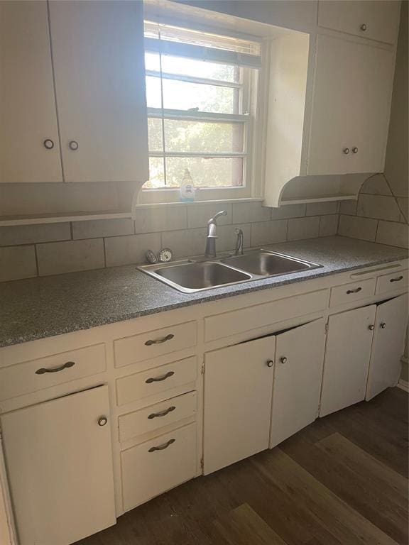 kitchen with tasteful backsplash, sink, white cabinets, and dark hardwood / wood-style flooring