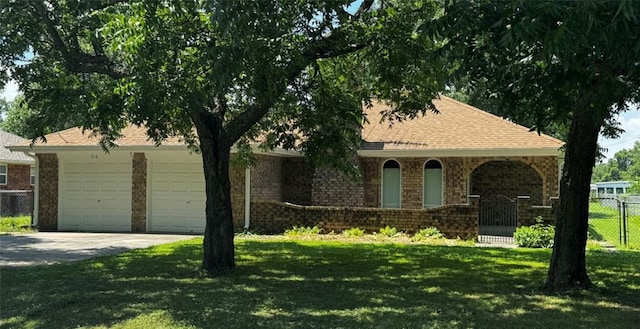 view of front of house featuring a front yard and a garage