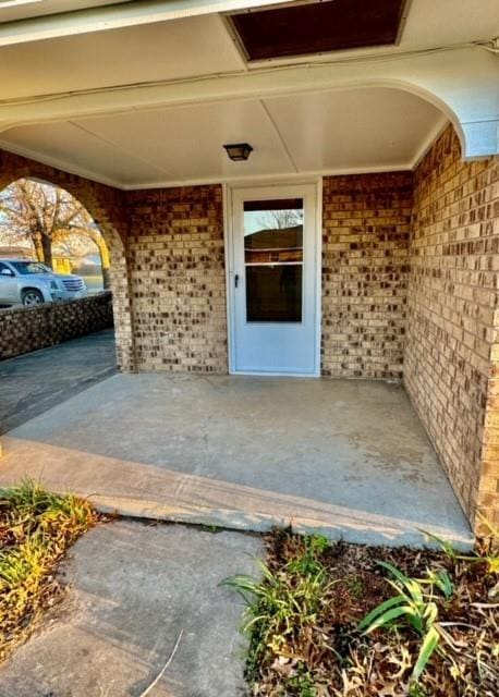 property entrance featuring a patio area