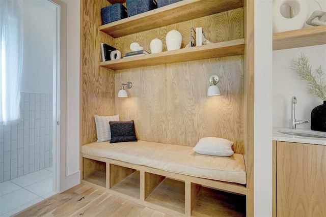 mudroom featuring sink and light hardwood / wood-style flooring