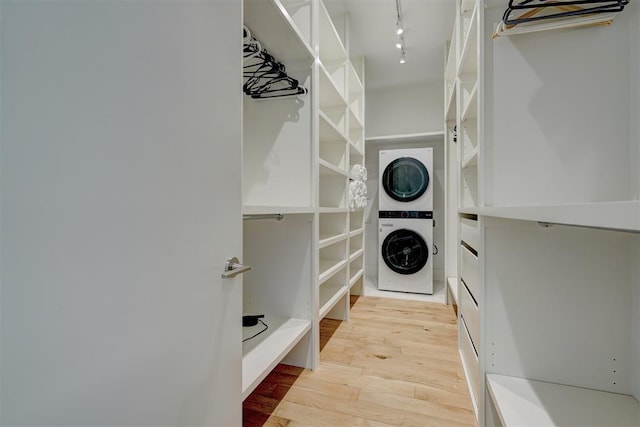 interior space featuring stacked washer / dryer and light hardwood / wood-style floors