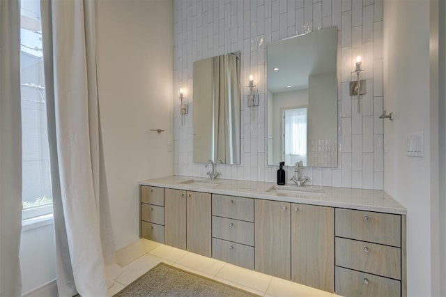 bathroom with a wealth of natural light, decorative backsplash, and vanity