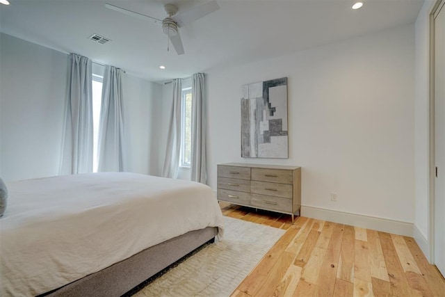 bedroom with light hardwood / wood-style flooring and ceiling fan