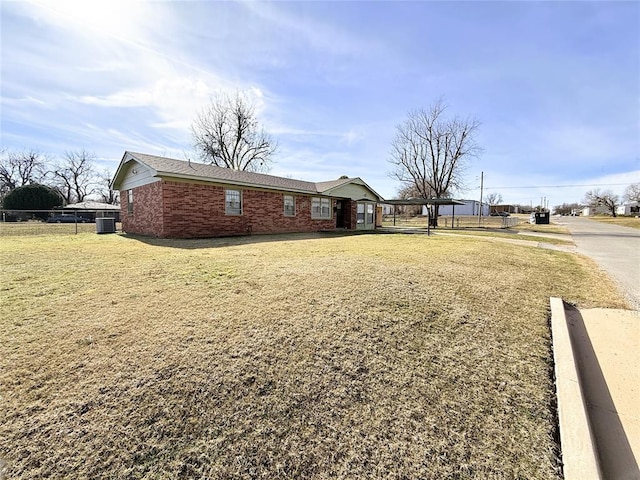 view of front of home with central air condition unit and a front lawn