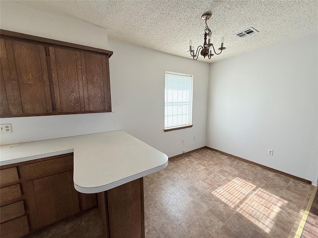 unfurnished dining area featuring an inviting chandelier