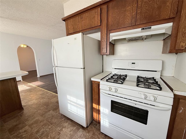 kitchen with a textured ceiling and white appliances