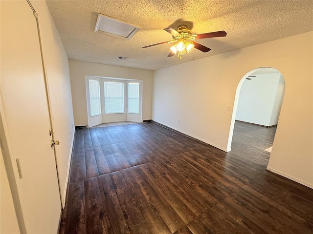 empty room featuring ceiling fan, dark hardwood / wood-style flooring, and a textured ceiling