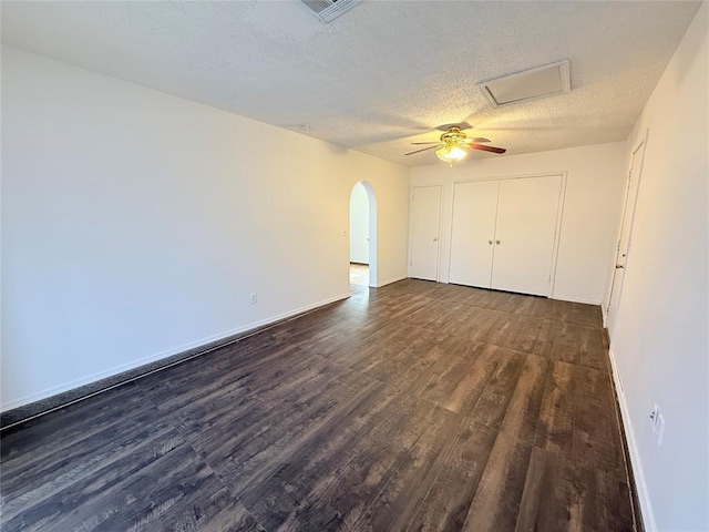 unfurnished room featuring dark hardwood / wood-style flooring and a textured ceiling