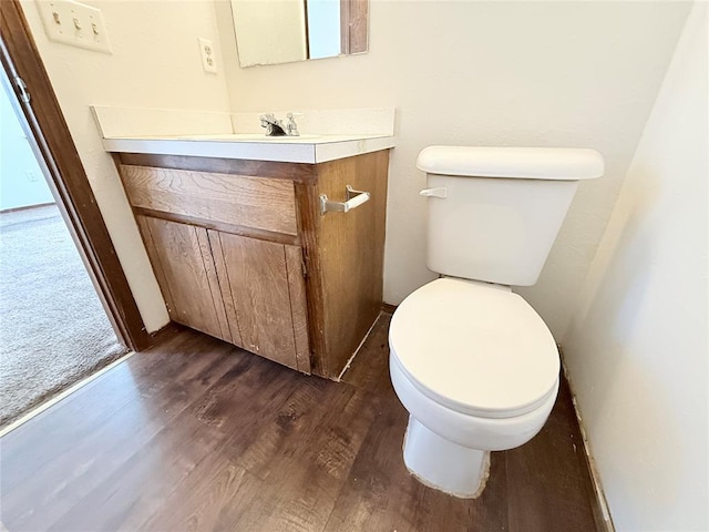 bathroom featuring hardwood / wood-style floors, vanity, and toilet