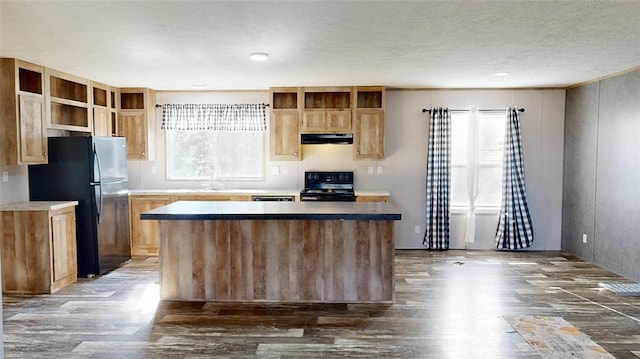 kitchen featuring black appliances, a center island, dark hardwood / wood-style flooring, and sink