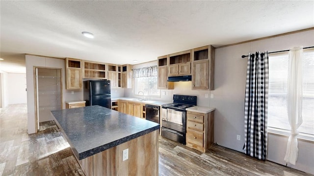 kitchen with dark wood-type flooring, black appliances, sink, light brown cabinetry, and a kitchen island