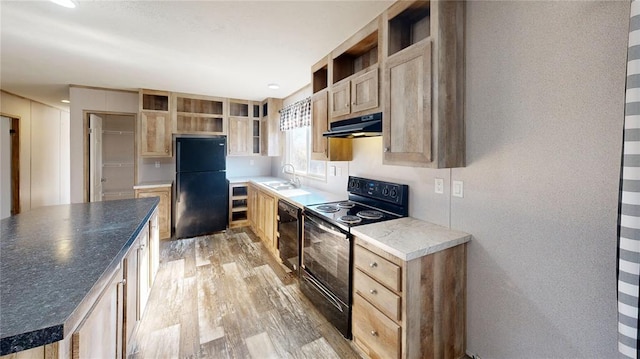 kitchen featuring light brown cabinetry, sink, black appliances, and light hardwood / wood-style floors