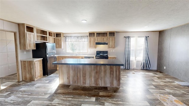 kitchen with black appliances, a center island, and sink