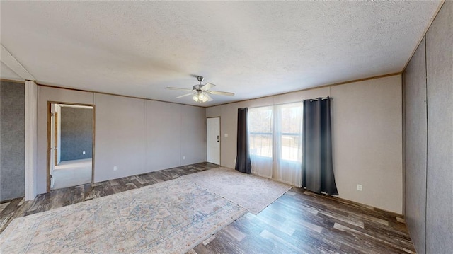 unfurnished room with ceiling fan, dark hardwood / wood-style flooring, and a textured ceiling