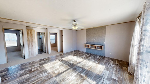 unfurnished living room with ceiling fan and hardwood / wood-style floors