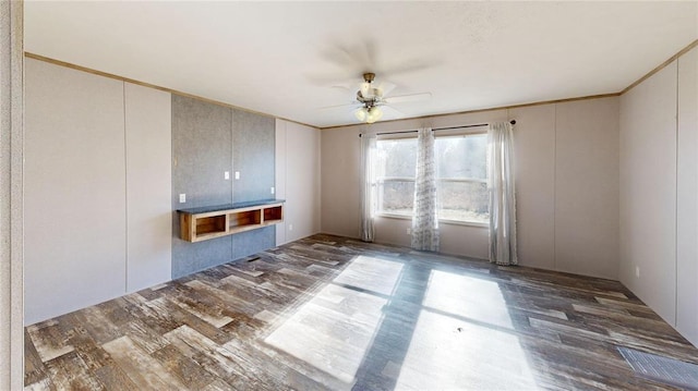 unfurnished living room with ceiling fan and dark hardwood / wood-style flooring