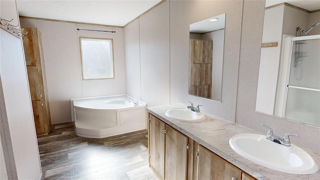 bathroom with vanity, shower with separate bathtub, wood-type flooring, and crown molding