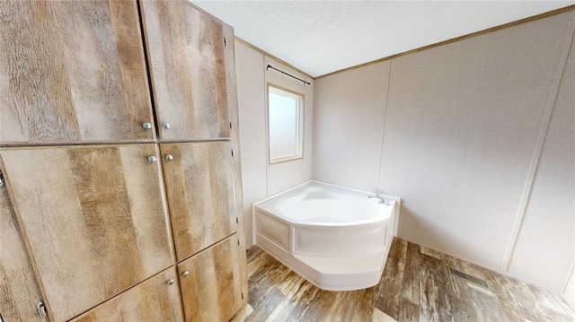 bathroom featuring hardwood / wood-style flooring and a bathing tub