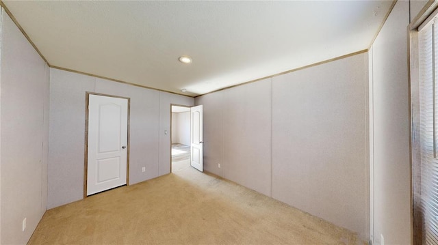 carpeted spare room with crown molding