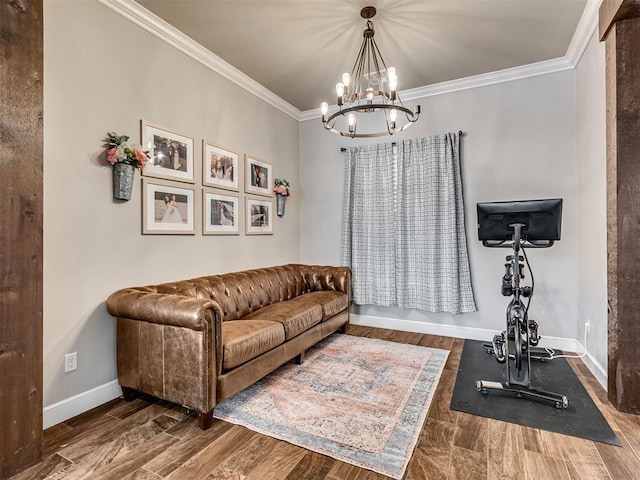 exercise room featuring ornamental molding and a notable chandelier