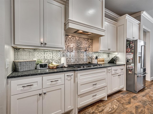 kitchen with premium range hood, tasteful backsplash, ornamental molding, appliances with stainless steel finishes, and white cabinets