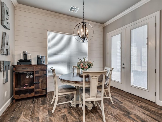 dining area with ornamental molding, dark hardwood / wood-style floors, a chandelier, and french doors