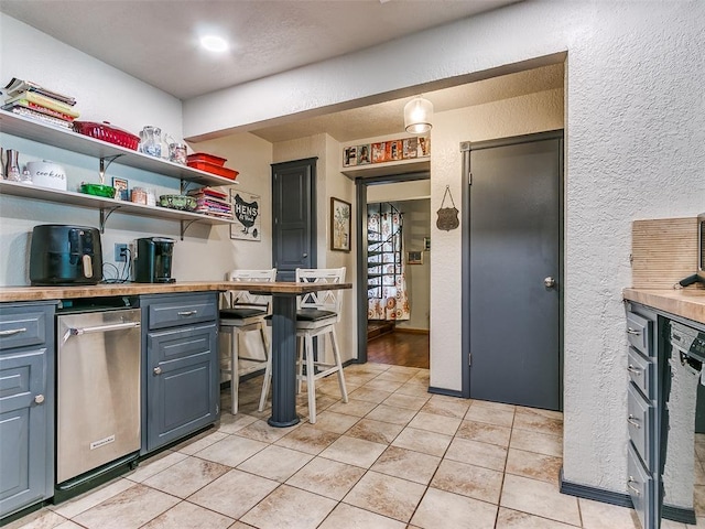 kitchen with dishwasher and light tile patterned floors