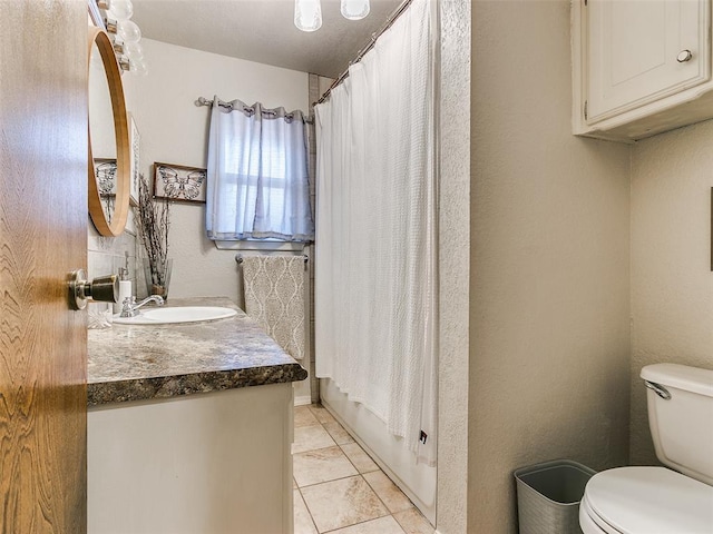 full bathroom featuring tile patterned flooring, vanity, toilet, and shower / tub combo with curtain