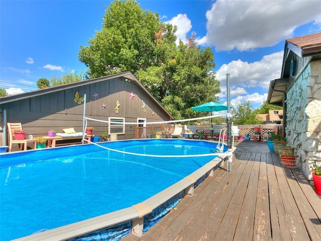 view of pool with a wooden deck