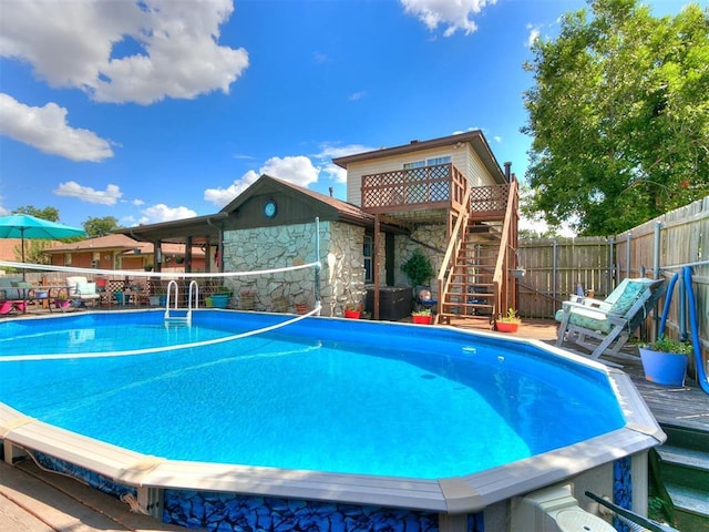 view of swimming pool featuring a wooden deck