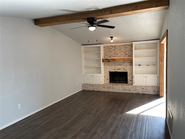 unfurnished living room featuring dark hardwood / wood-style flooring, a textured ceiling, ceiling fan, built in features, and a fireplace