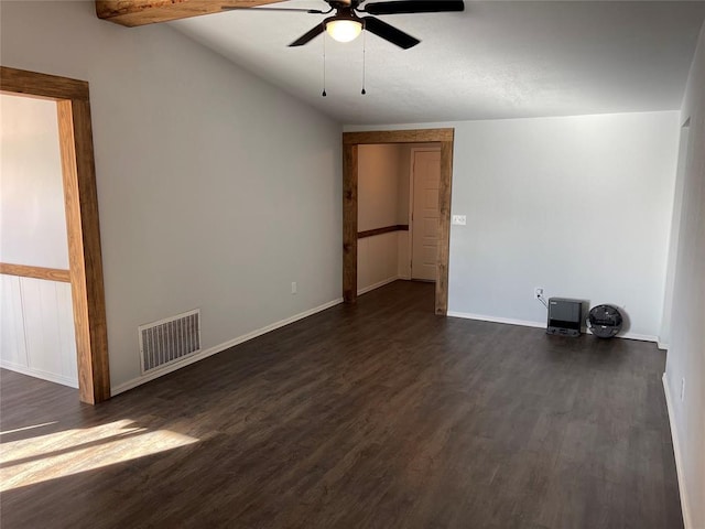 spare room with vaulted ceiling with beams, ceiling fan, and dark wood-type flooring