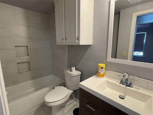 full bathroom with tiled shower / bath, tile patterned flooring, vanity, and toilet