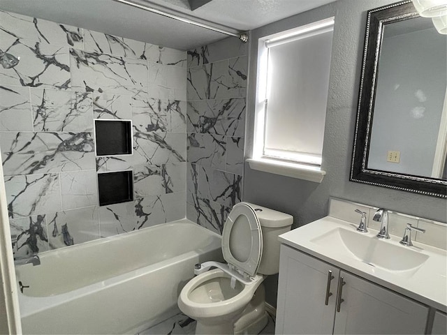 full bathroom featuring vanity, tiled shower / bath combo, and toilet