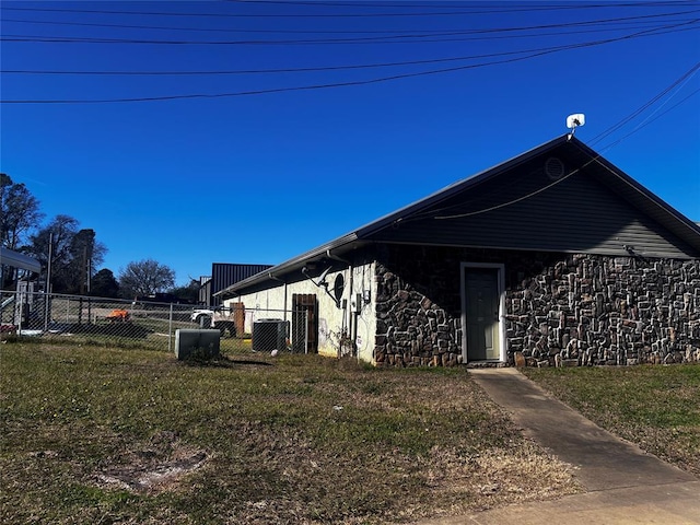 view of property exterior featuring a yard and central AC