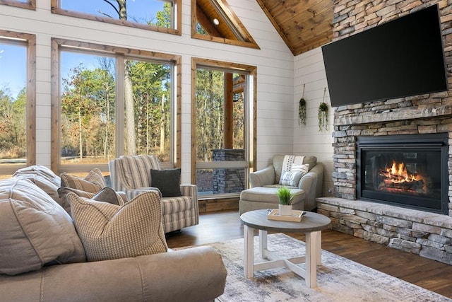 sunroom featuring a fireplace, wood ceiling, and lofted ceiling