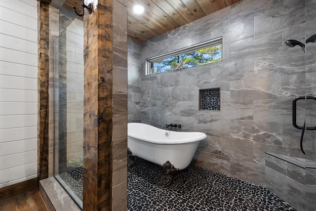 bathroom with wooden ceiling and shower with separate bathtub