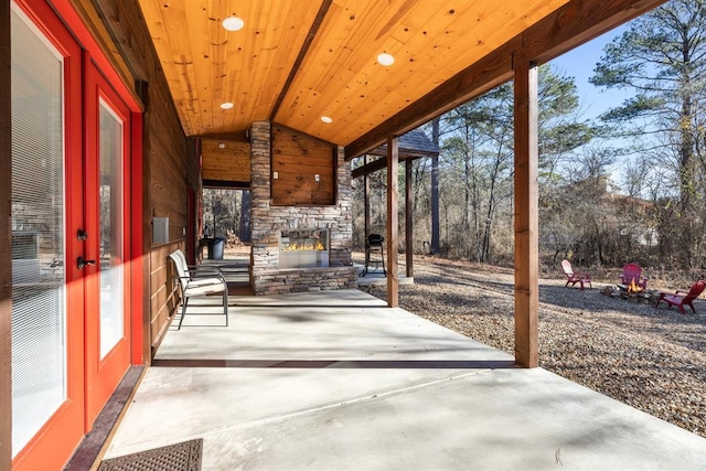 view of patio featuring an outdoor stone fireplace