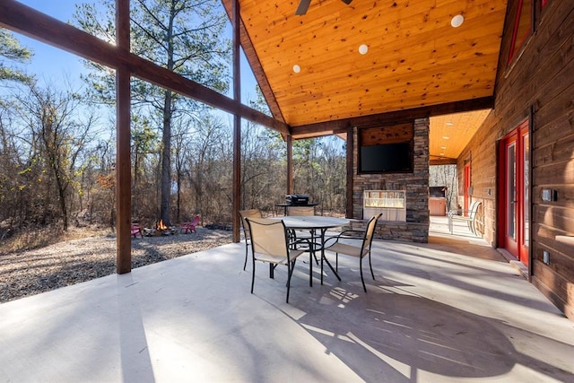 view of patio / terrace with an outdoor stone fireplace and ceiling fan