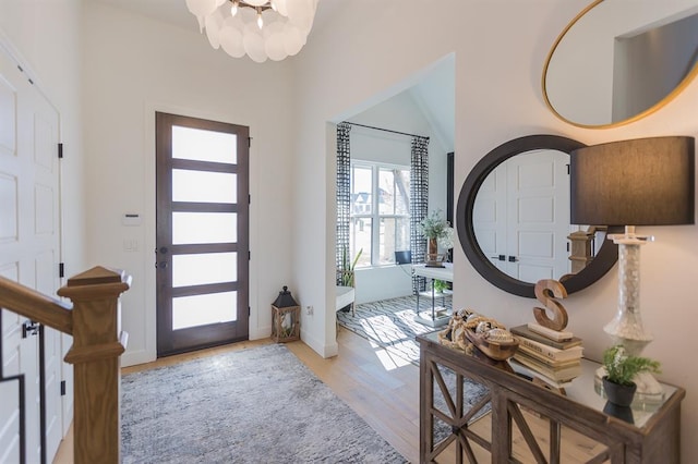 foyer with a chandelier and light wood-type flooring