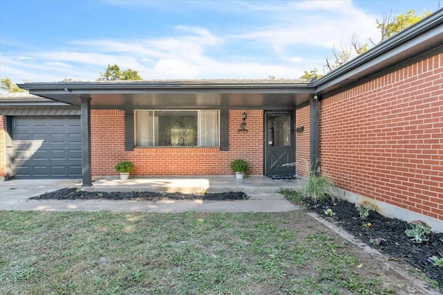 view of exterior entry with a garage