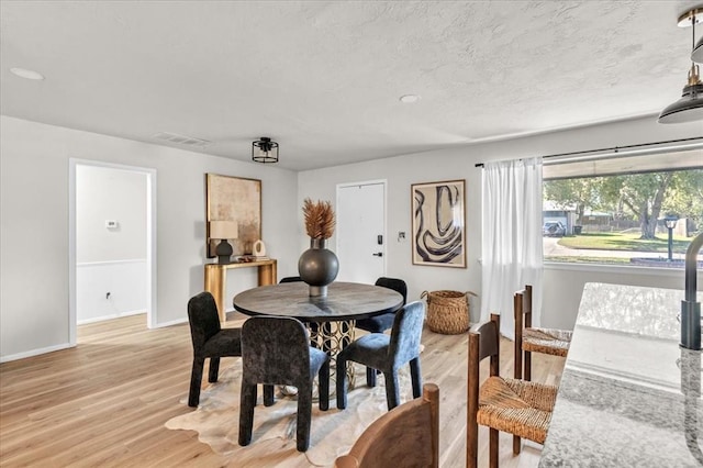 dining space featuring light wood-type flooring