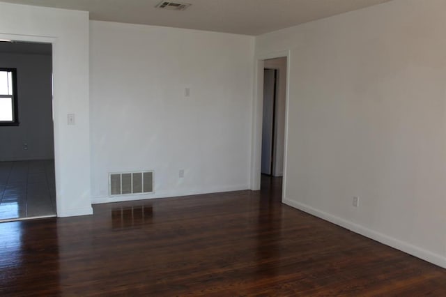 spare room featuring dark hardwood / wood-style floors