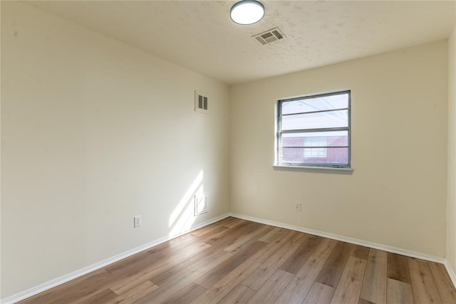 unfurnished room with light wood-type flooring