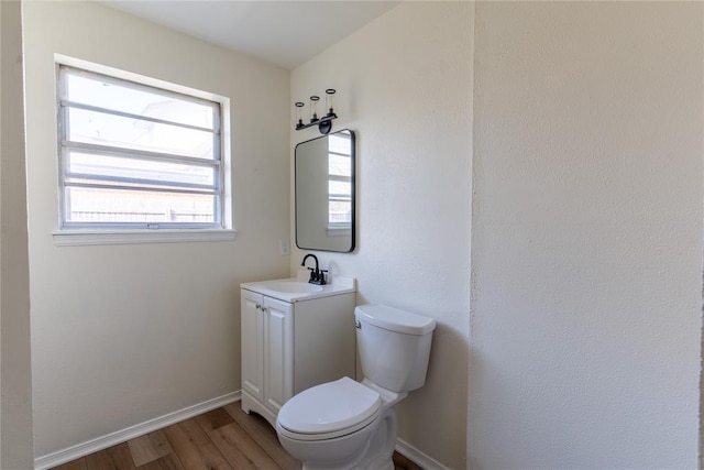 bathroom featuring hardwood / wood-style floors, vanity, and toilet